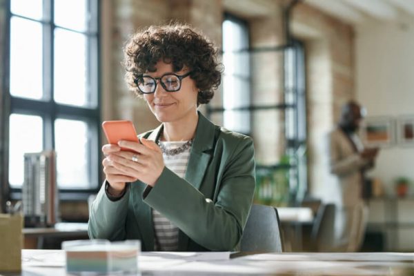 businesswoman-using-smartphone-at-her-workplace-2022-06-28-14-05-22-utc-1.jpg
