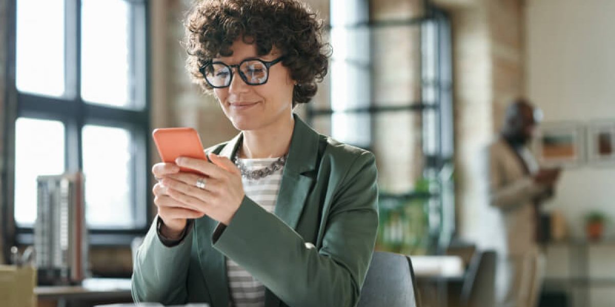 businesswoman-using-smartphone-at-her-workplace-2022-06-28-14-05-22-utc-1.jpg